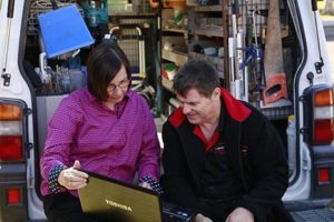 Vicki Yen and business owner sitting by work van