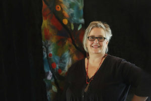 rtist Wendy Bailys from Brisbane stands with her felt art piece.